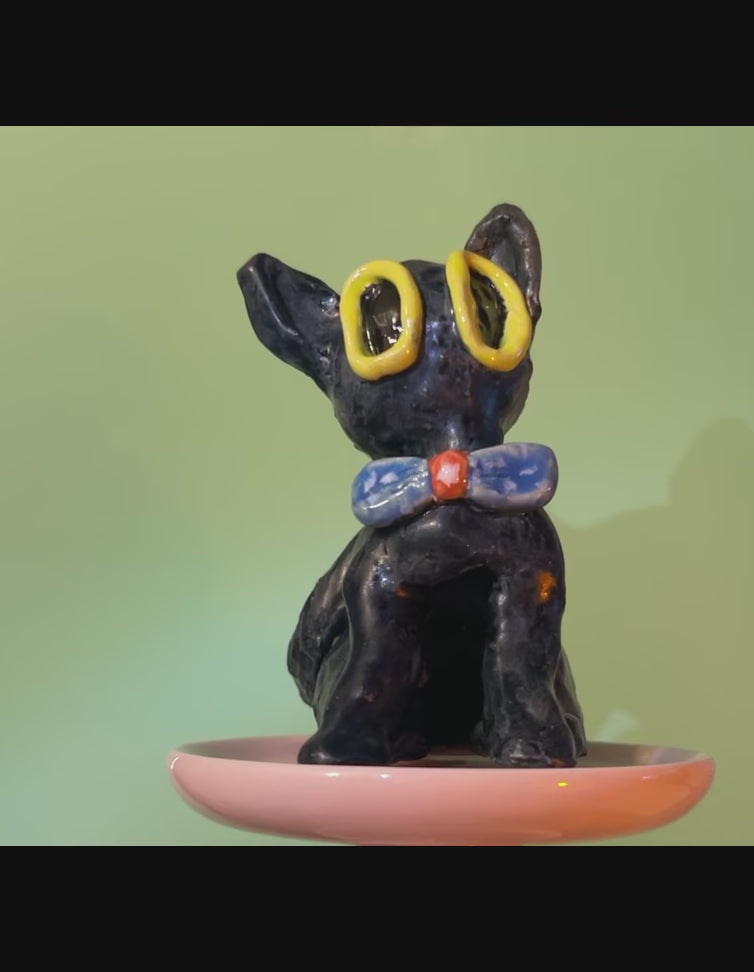 ceramic black cat figurine with blue bowtie rotating 360 degrees